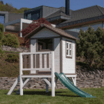 בית עץ לילדים מוגבה עם מרפסת ומגלשה ירוקה בחצר | yrz