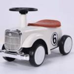 בימבה וינטג׳ לפעוטות בצבע שמנת עם מושב חום, גלגלים שחורים והגה, מספר 6 בצד